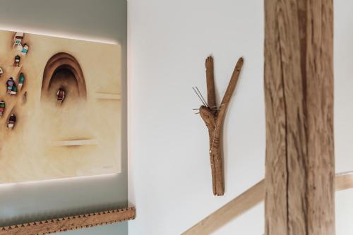 a clock on a wall next to a wooden stick at Apres Ski Bachleda - LoftAffair Collection in Zakopane