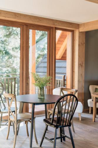 a table and chairs with a vase on it at Apres Ski Bachleda - LoftAffair Collection in Zakopane