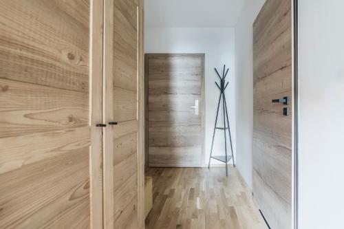 a room with wooden walls and a door at Apres Ski Bachleda - LoftAffair Collection in Zakopane