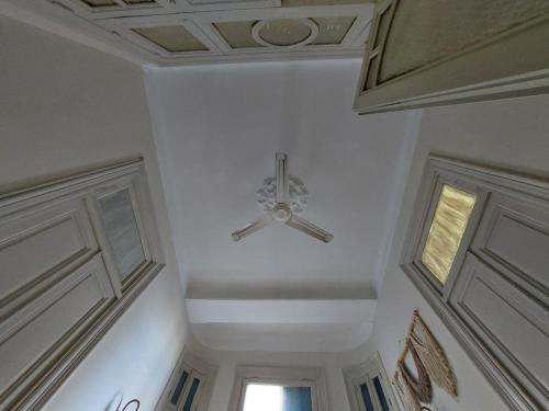 a ceiling fan in a room with a white ceiling at Alexandria private rooms, Only For Men 仅限男士 in Alexandria