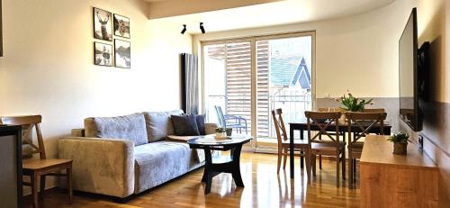 a living room with a couch and a table at VIP Apartamenty Stara Polana 2 in Zakopane