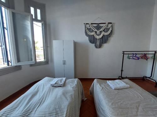 a room with two beds and a refrigerator in it at Alexandria private rooms, Only For Men 仅限男士 in Alexandria