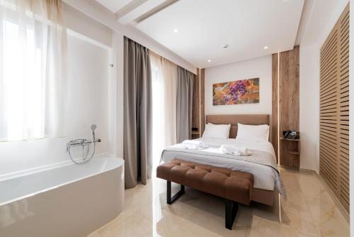 a bedroom with a bed and a bath tub at The Wine Hotel in Rhodes Town