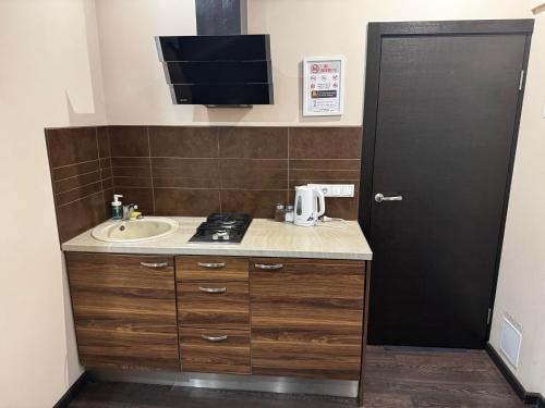 a bathroom with a sink and a counter with a sink at ApartHotel Riga in Rīga