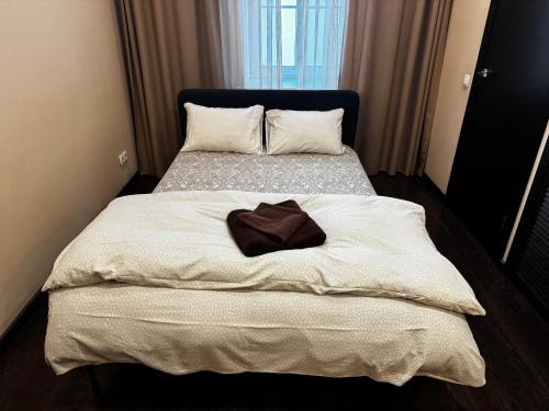 a bedroom with two beds with a robe on it at ApartHotel Riga in Rīga