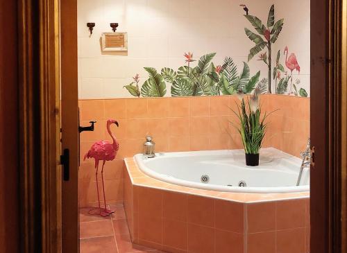 a bathroom with a tub with a flamingo in it at Alojamientos Rurales EL VALLEJO in Puebla de Vallés