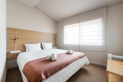 Ένα ή περισσότερα κρεβάτια σε δωμάτιο στο GuestReady - A charming duplex home near Boavista
