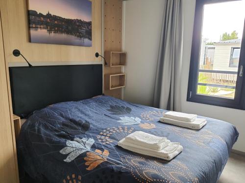 une chambre avec un lit avec deux serviettes dessus dans l'établissement Cottage 4-6 pers-piscine chauffée-150m plage, à Jullouville
