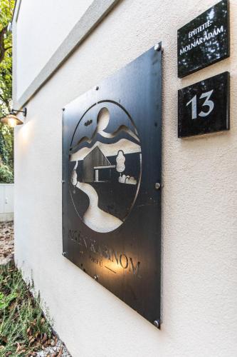a sign for a tavern on the side of a building at Az én kabinom Orfű in Orfű
