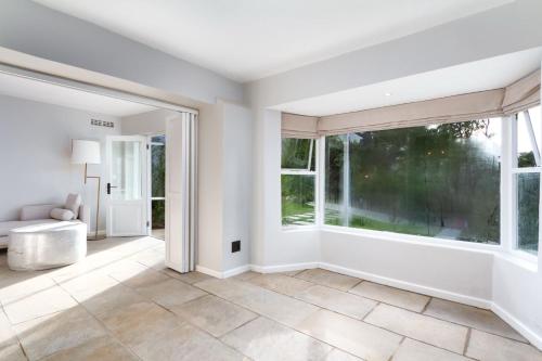 an empty living room with a large window at Bay Haven Collection in Cape Town
