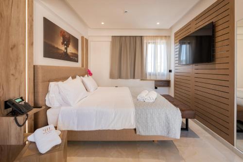 a hotel room with a bed and a television at The Wine Hotel in Rhodes Town