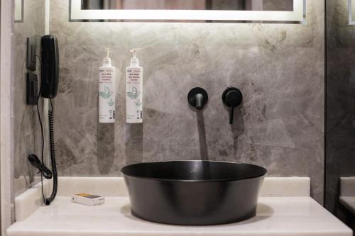 a black bowl on a counter in a bathroom at The Wine Hotel in Rhodes Town