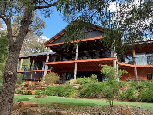 a building with a tree in front of it at Arum - Close to the Margaret River in Margaret River Town