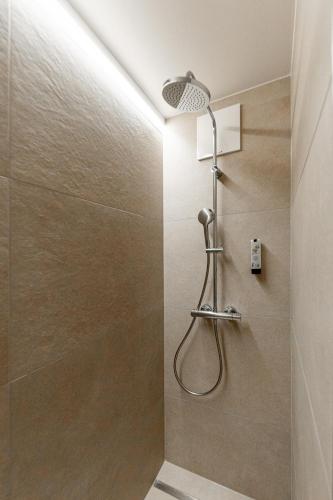 a shower with a shower head in a bathroom at Avita Resort Bad Tatzmannsdorf in Bad Tatzmannsdorf