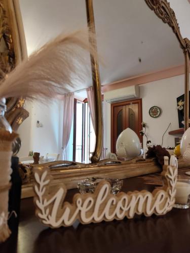 a mirror with the word welcome in front of it at Stella House in Fasano
