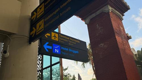 a street sign in front of a building at Novotel Bali Ngurah Rai Airport in Kuta