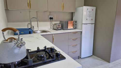 a kitchen with a stove and a refrigerator at 43 on Bergview in Hilton