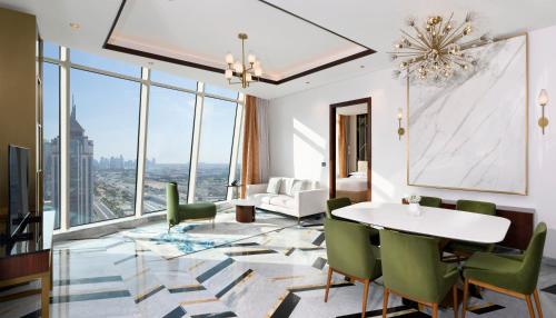 a living room with a table and chairs at Velero Hotel Doha Lusail in Doha