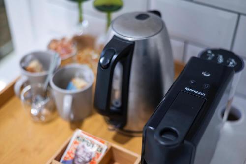 a coffee pot on a counter with a remote control at The Willets Boutique Hotel in Simon's Town in Simonʼs Town