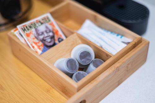 a wooden box with cups and plates in it at The Willets Boutique Hotel in Simon's Town in Simonʼs Town