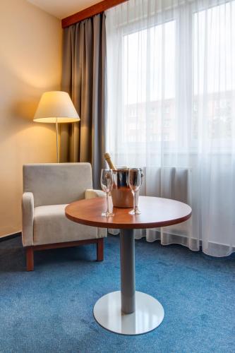 a room with a table and a chair and a window at LC - Hotel Ostrava in Ostrava