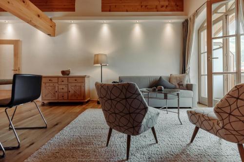 a living room with a couch and chairs and a table at Ferienwohnungen Renberg in Maria Alm am Steinernen Meer