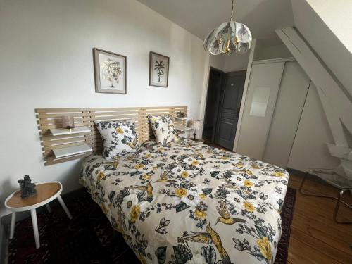 a bedroom with a bed and a table at La Visitation - 30 in Orthez