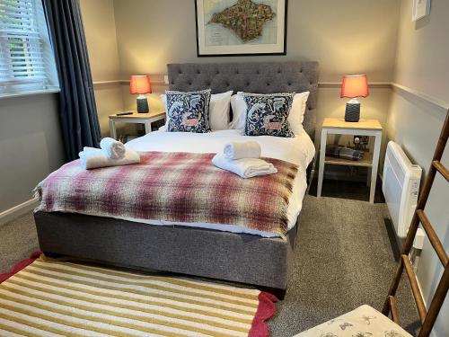 a bedroom with a bed with two towels on it at St Marys Gate Inn in Arundel