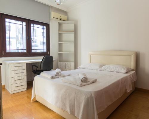 a bedroom with a bed with towels on it at Peanut House by HolidayKeys in Kérynia