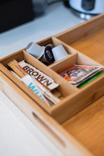 a wooden box with magazines and books on a table at The Willets Boutique Hotel in Simon's Town in Simonʼs Town