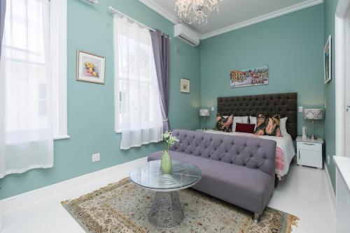 a living room with a couch and a bed at The Willets Boutique Hotel in Simon's Town in Simonʼs Town