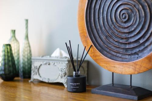 a sculpture of a spiral on a table with vases at The Willets Boutique Hotel in Simon's Town in Simonʼs Town