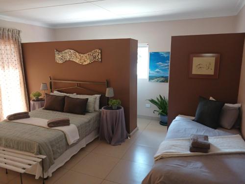 a large bedroom with two beds and a window at 19 Richthofen in Swakopmund