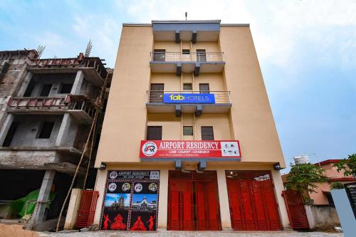 a building with a sign on the front of it at FabHotel Airport Residency I in Khandagiri