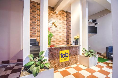 a lobby with a job sign on a brick wall at FabHotel Airport Residency I in Khandagiri