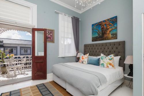 a bedroom with a bed and a window at The Willets Boutique Hotel in Simon's Town in Simonʼs Town