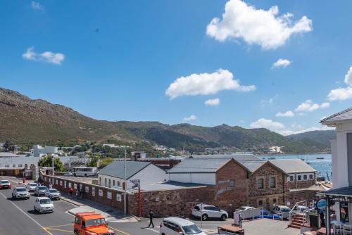 a view of a town with cars parked in a parking lot at The Willets Boutique Hotel in Simon's Town in Simonʼs Town