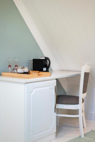 a white desk with a chair in a room at The Willets Boutique Hotel in Simon's Town in Simonʼs Town