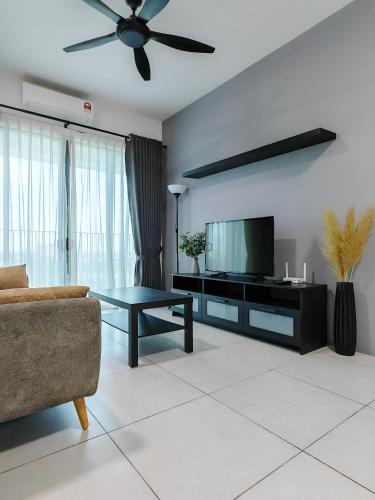 a living room with a couch and a television at Meritus - Perai, Penang in Perai