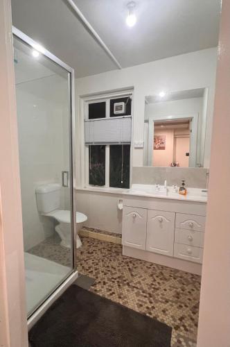 a bathroom with a toilet and a sink at Vista Bliss in Sandy Bay