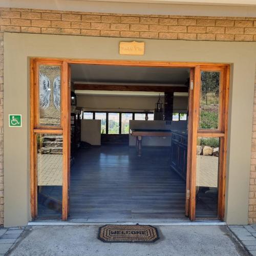 an open door of a building with a piano at The Fat Mulberry Guest Farm in Fouriesburg