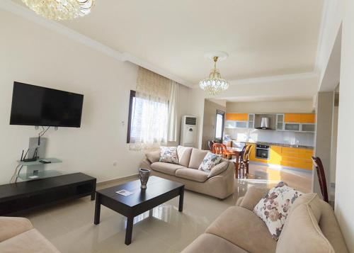 a living room with two couches and a table at Peanut House by HolidayKeys in Kérynia