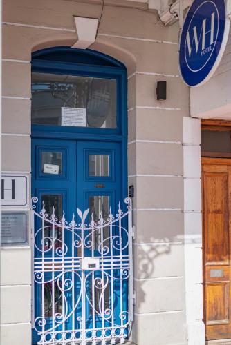 a blue door on the side of a building at The Willets Boutique Hotel in Simon's Town in Simonʼs Town