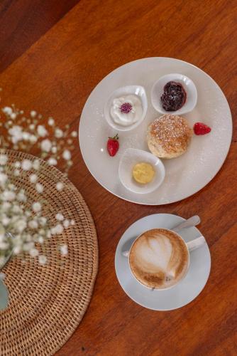 two plates of food and a cup of coffee on a table at The Willets Boutique Hotel in Simon's Town in Simonʼs Town