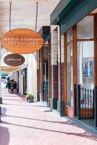 a street with a sign for a shopping center at The Willets Boutique Hotel in Simon's Town in Simonʼs Town