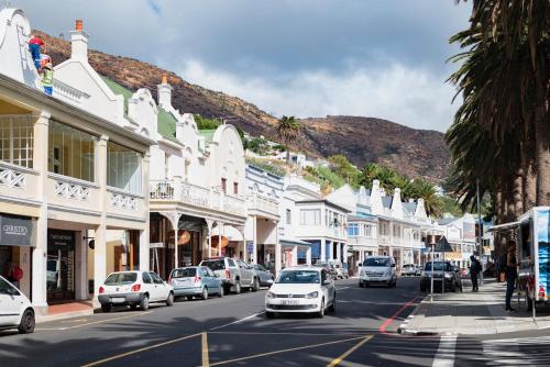 a city street with cars parked on the street at The Willets Boutique Hotel in Simon's Town in Simonʼs Town