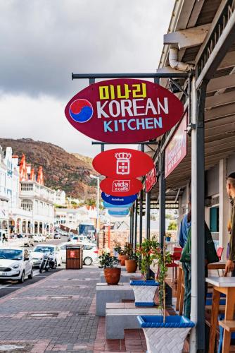 a sign for a korean kitchen on a street at The Willets Boutique Hotel in Simon's Town in Simonʼs Town