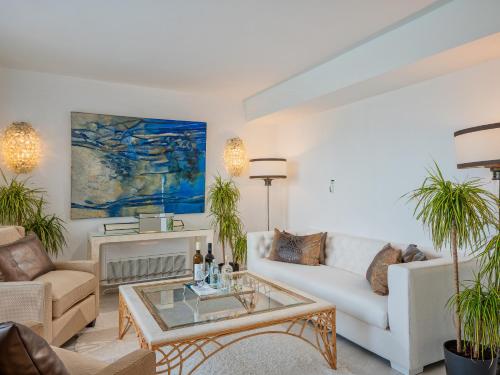 a living room with a couch and a table at Grecotel Creta Palace in Rethymno Town