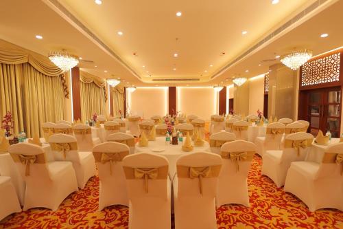 a banquet hall with white tables and chairs in a room at Regenta Orko's Haridwar, Motichur, 10 min from Har ki Pauri in Haridwār