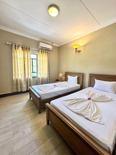 Ένα ή περισσότερα κρεβάτια σε δωμάτιο στο La Digue Island Lodge
